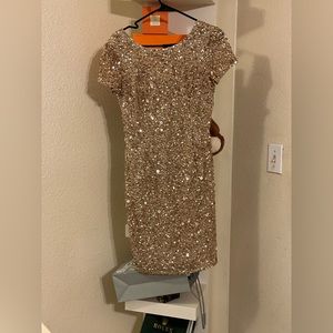 Scoop back, slimming and petite. This blush gown looks great on every figure 👗